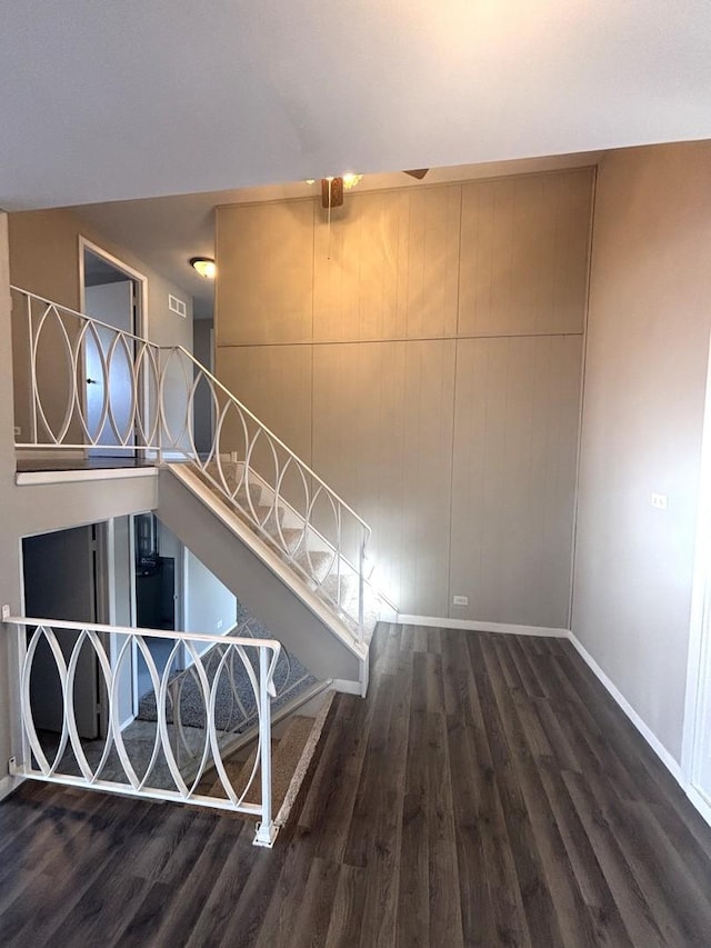 staircase featuring wood-type flooring