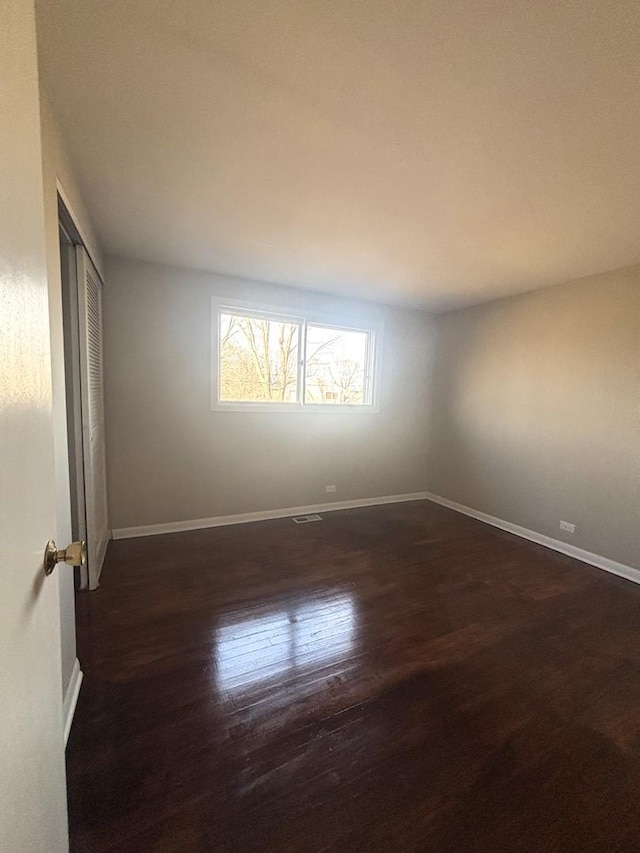 empty room featuring dark wood-type flooring