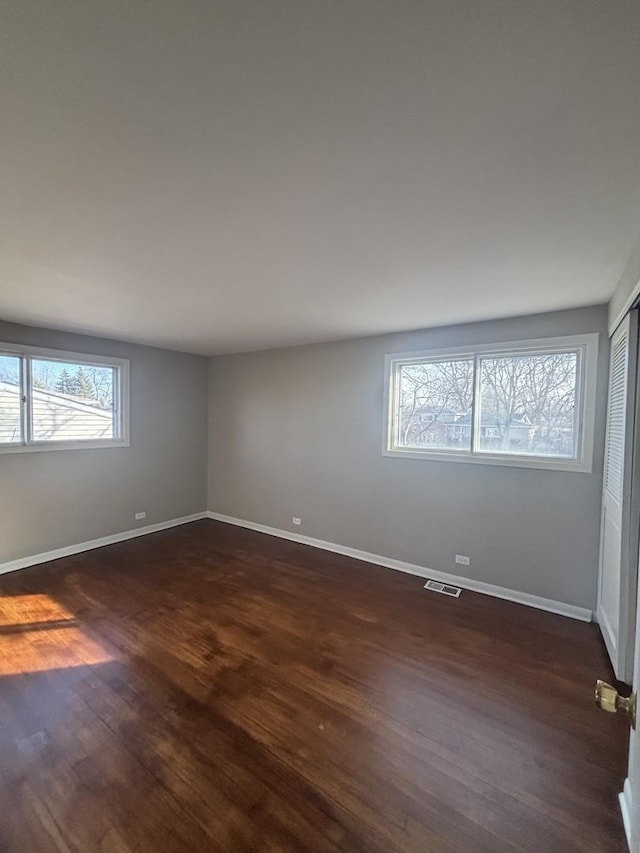 unfurnished room featuring dark wood-type flooring