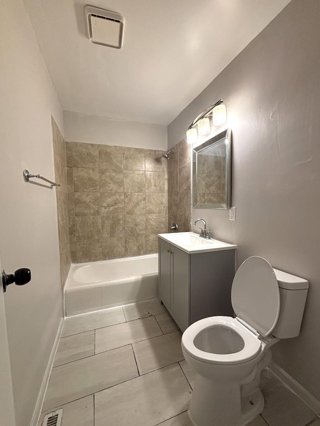 full bathroom featuring tiled shower / bath, vanity, and toilet