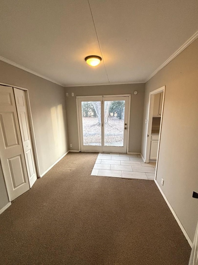 unfurnished room with ornamental molding and light carpet