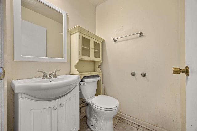 bathroom featuring tile patterned floors, vanity, and toilet