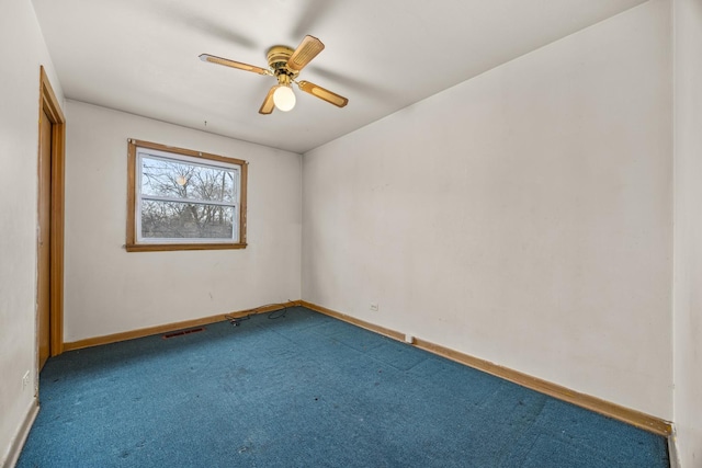 spare room featuring carpet floors and ceiling fan