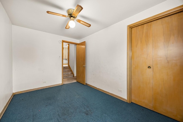 unfurnished bedroom with carpet flooring, ceiling fan, and a closet