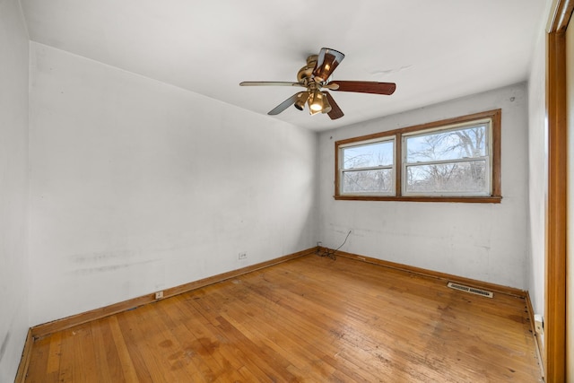 empty room with ceiling fan and light wood-type flooring