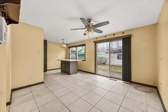 tiled empty room with ceiling fan