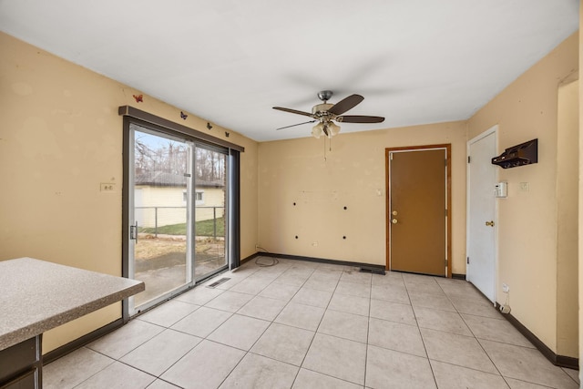 tiled spare room featuring a water view and ceiling fan