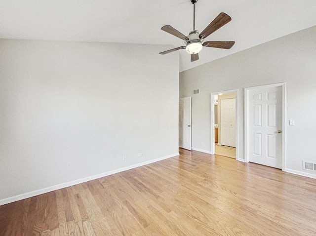 unfurnished room featuring ceiling fan, high vaulted ceiling, and light wood-type flooring