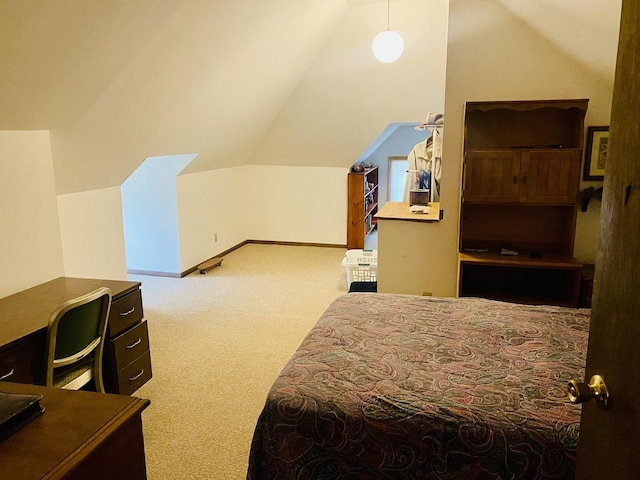 bedroom with lofted ceiling and carpet floors