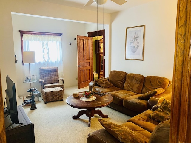 carpeted living room featuring ceiling fan