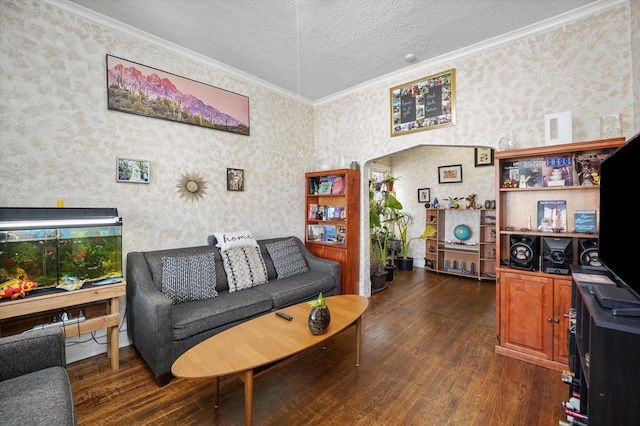 living room featuring wallpapered walls, dark wood finished floors, and crown molding