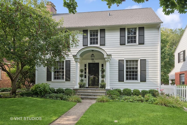 colonial-style house with a front lawn