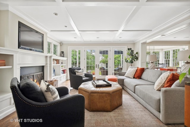 living room featuring coffered ceiling, crown molding, light hardwood / wood-style floors, and french doors