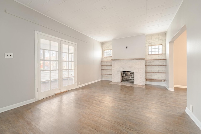 unfurnished living room featuring a fireplace and wood-type flooring