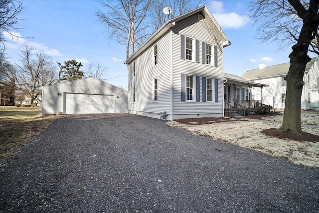 exterior space featuring a porch, crawl space, an outdoor structure, and a garage