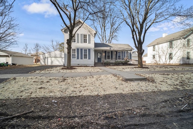 traditional home with covered porch, crawl space, a detached garage, and an outdoor structure