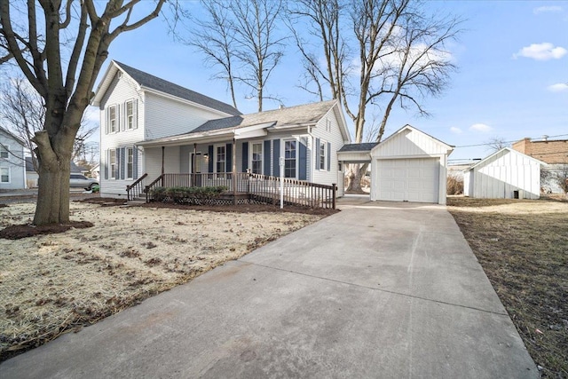 traditional-style home with an outdoor structure, concrete driveway, and covered porch