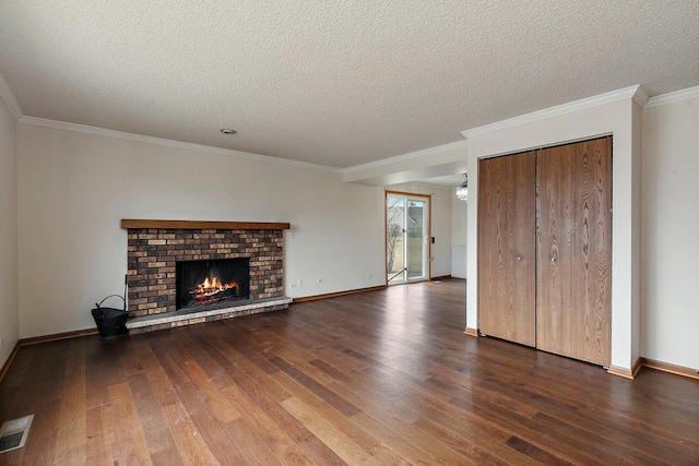 unfurnished living room featuring crown molding, wood-type flooring, a fireplace, and a textured ceiling