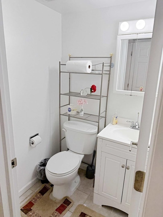 bathroom with vanity, tile patterned floors, and toilet