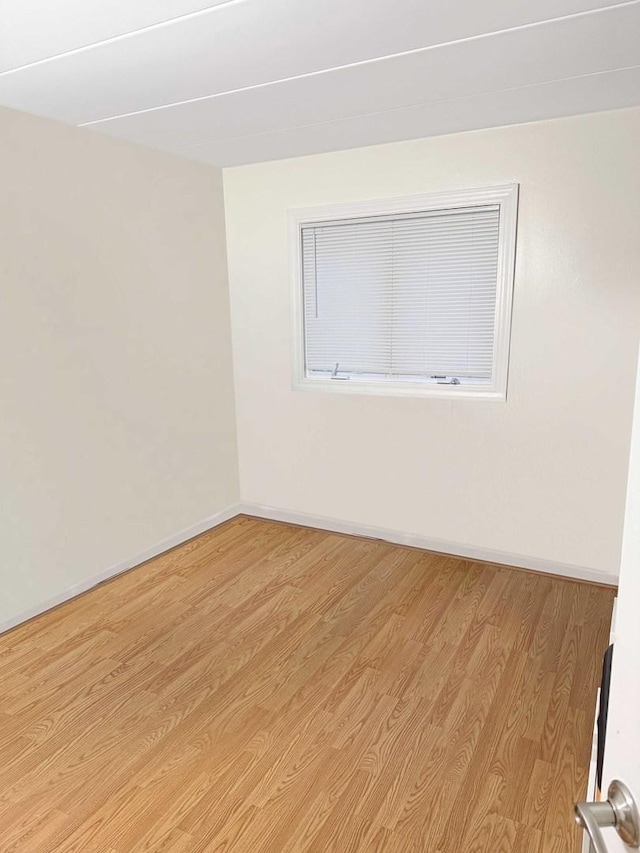 spare room featuring light wood-type flooring