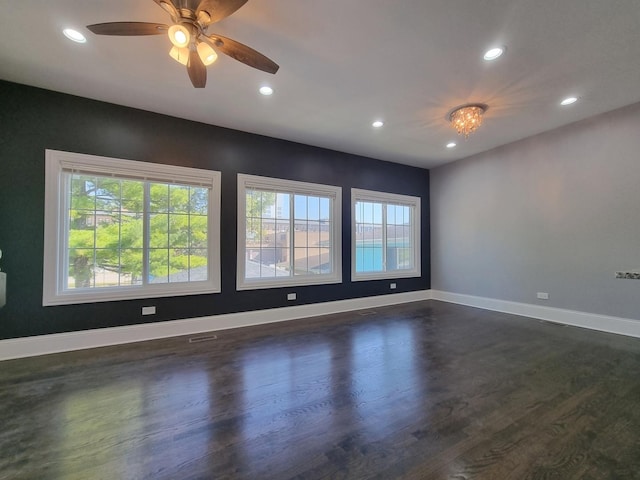 spare room featuring dark hardwood / wood-style floors, a wealth of natural light, and ceiling fan