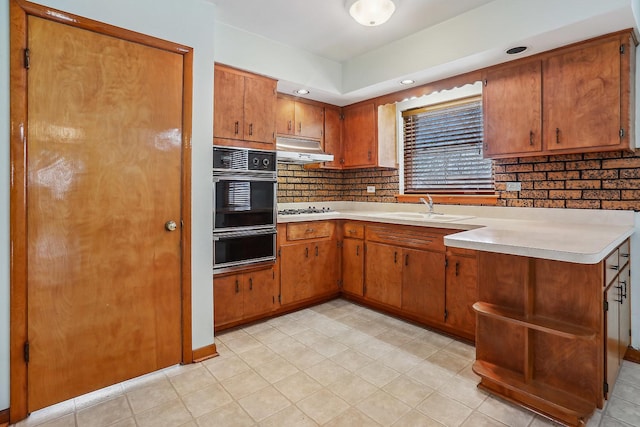 kitchen with sink, decorative backsplash, black oven, and white gas stovetop