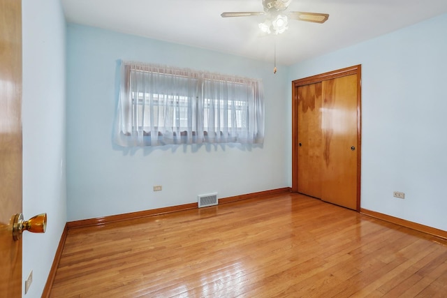 unfurnished bedroom with light hardwood / wood-style flooring and a closet