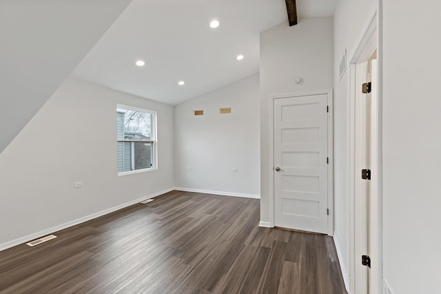 additional living space with dark hardwood / wood-style floors and lofted ceiling with beams