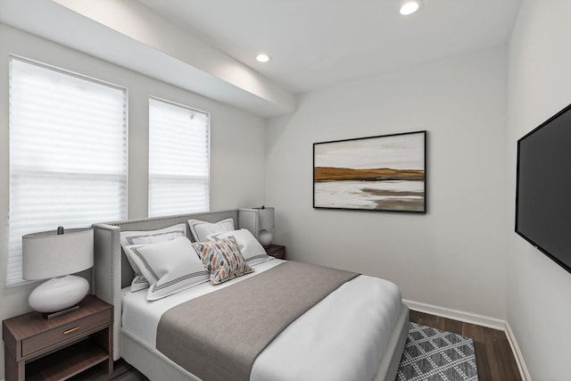 bedroom with dark hardwood / wood-style flooring