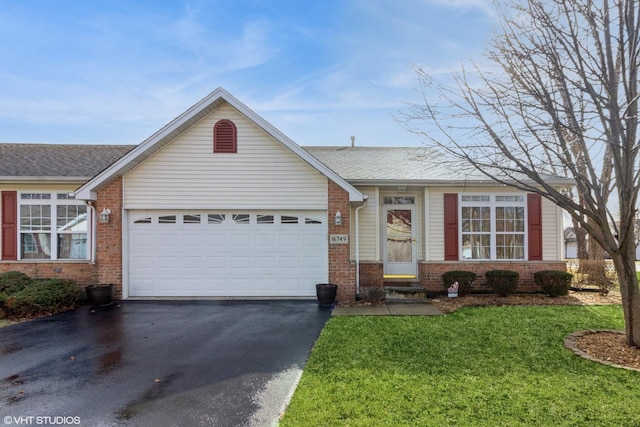 ranch-style home with a garage and a front lawn