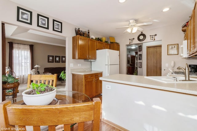 kitchen with ceiling fan, sink, and white appliances