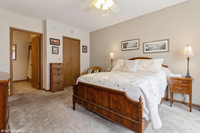 bedroom featuring ceiling fan, a closet, and light carpet