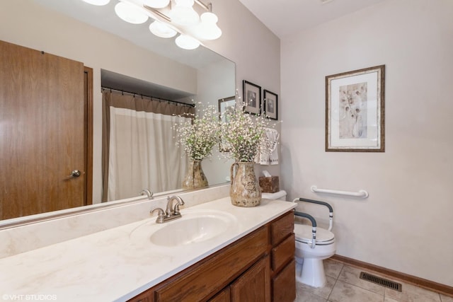 bathroom featuring vanity, tile patterned floors, toilet, and walk in shower