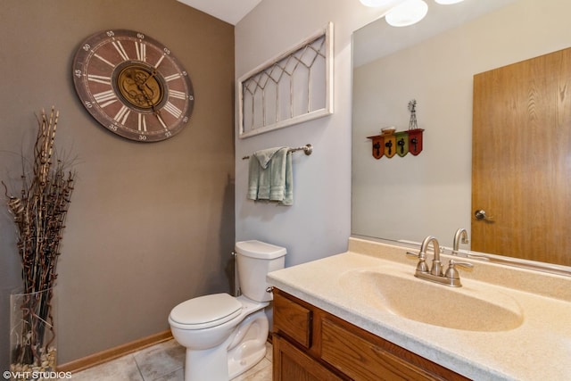 bathroom with vanity, tile patterned floors, and toilet