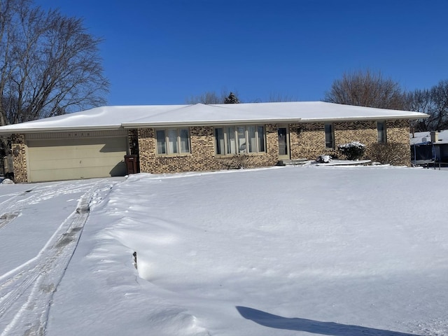 view of front of property with an attached garage and brick siding