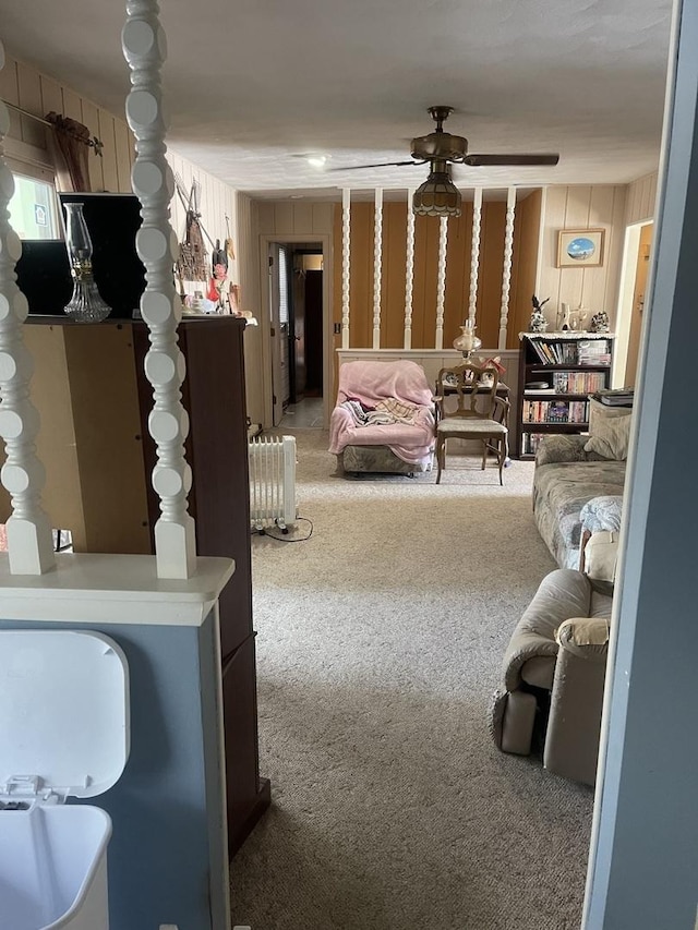 living room with carpet floors, radiator heating unit, and ceiling fan