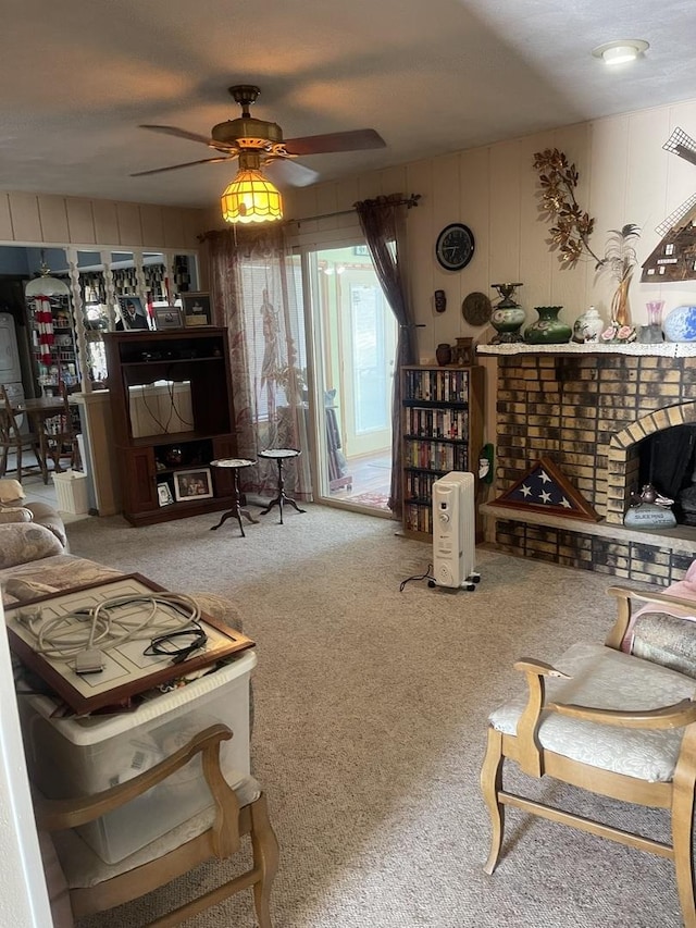 living area with ceiling fan, a fireplace, and carpet