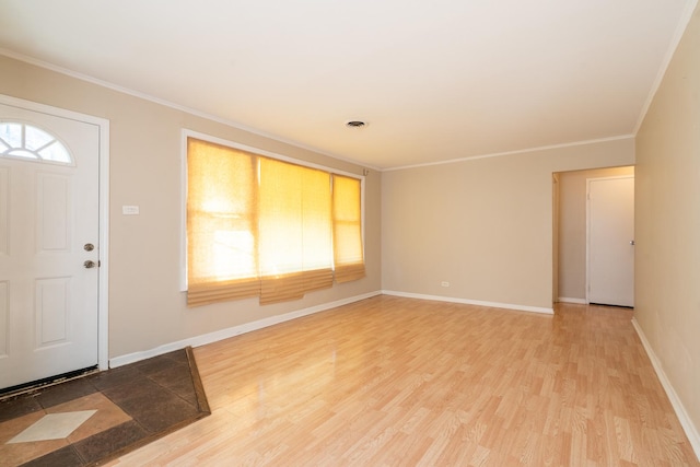 entrance foyer featuring ornamental molding and hardwood / wood-style floors