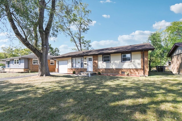 ranch-style home with a garage and a front yard