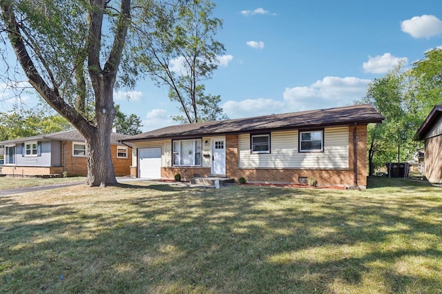 ranch-style home with a garage and a front yard