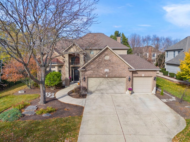 view of property featuring a front yard and a garage