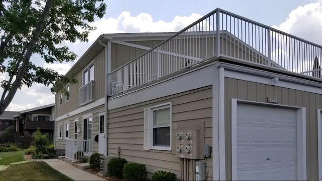 view of side of home with a balcony and central AC