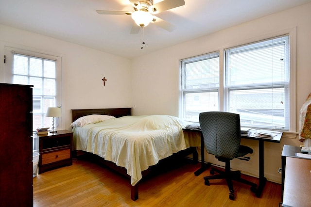 bedroom with light hardwood / wood-style floors and ceiling fan