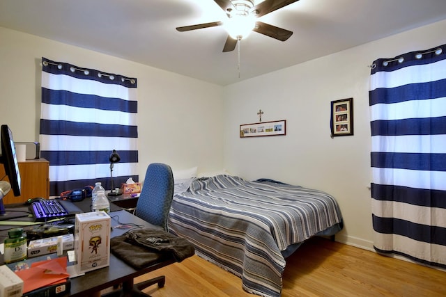 bedroom with ceiling fan and light wood-type flooring