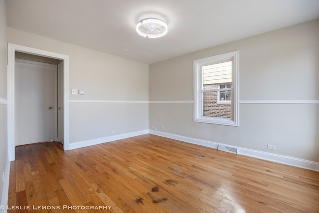 spare room featuring light wood-type flooring