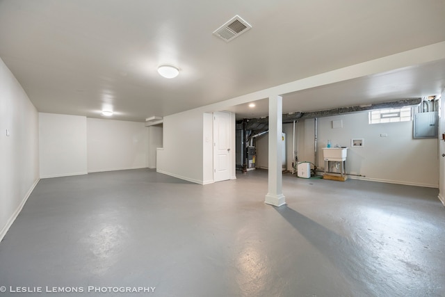 basement featuring electric panel and sink