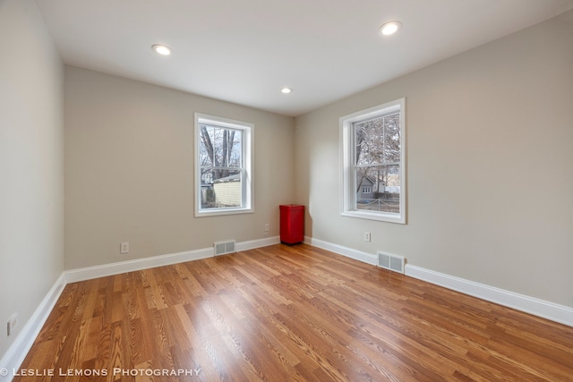 unfurnished room with hardwood / wood-style flooring