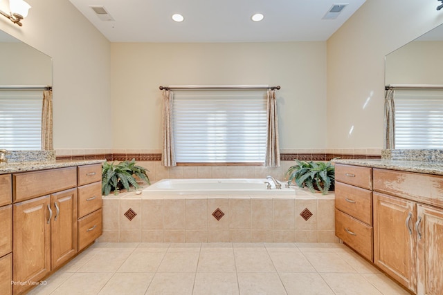 bathroom with vanity, tile patterned floors, and tiled bath