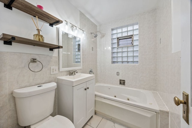 full bathroom featuring tile walls, vanity, toilet, and tiled shower / bath