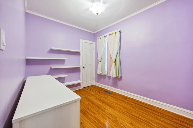 interior space featuring hardwood / wood-style floors and ornamental molding